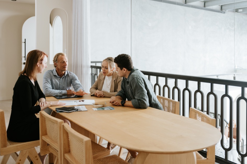 Professional estate lawyers meeting at large wooden table