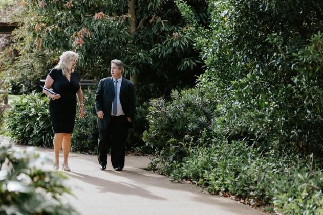 Two business professionals walking in park