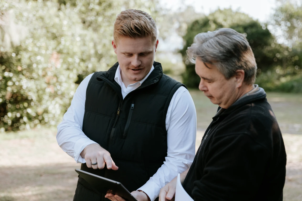 Two accountants looking at ipad and discussing payg instalments