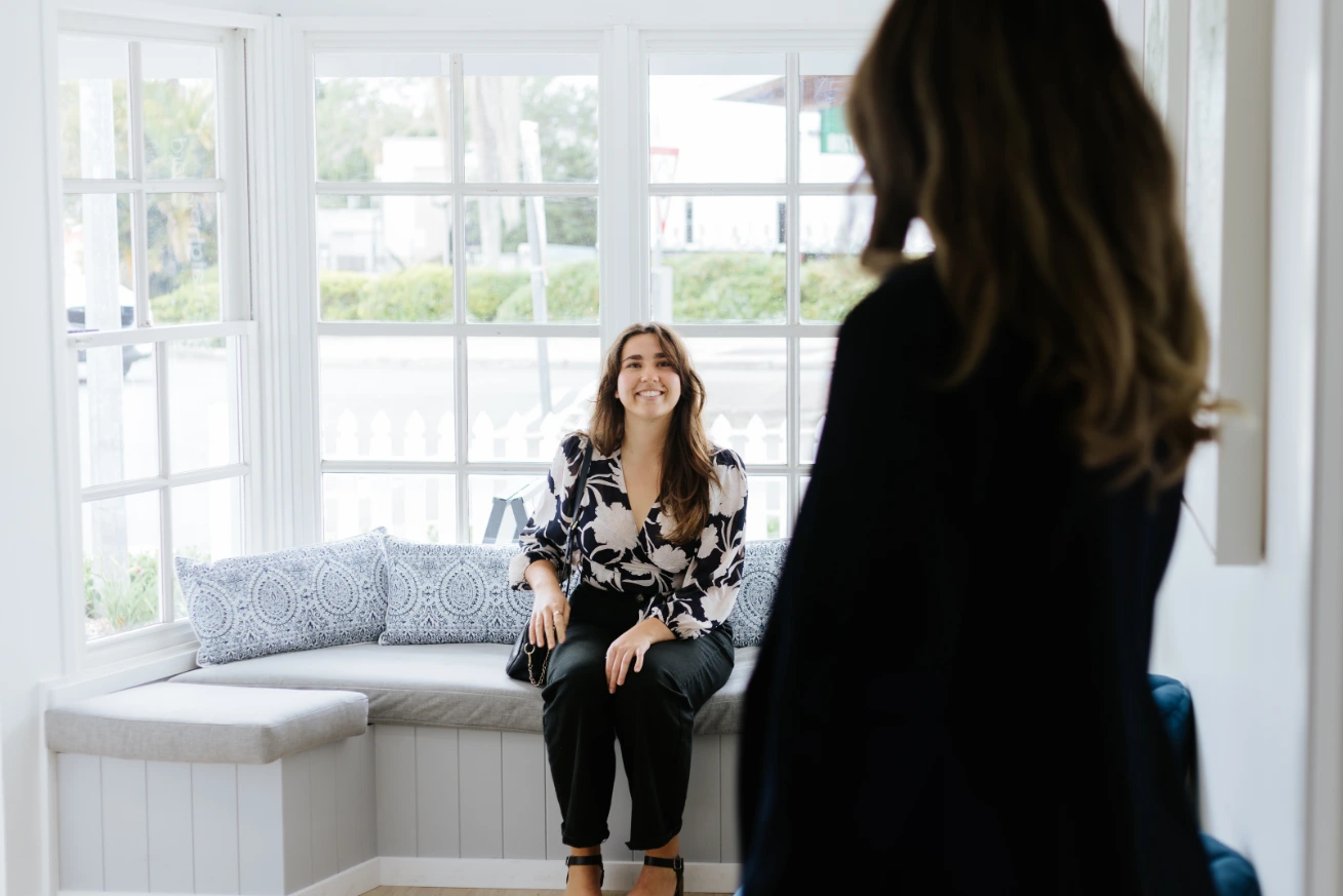 Smiling woman looking up at business professional