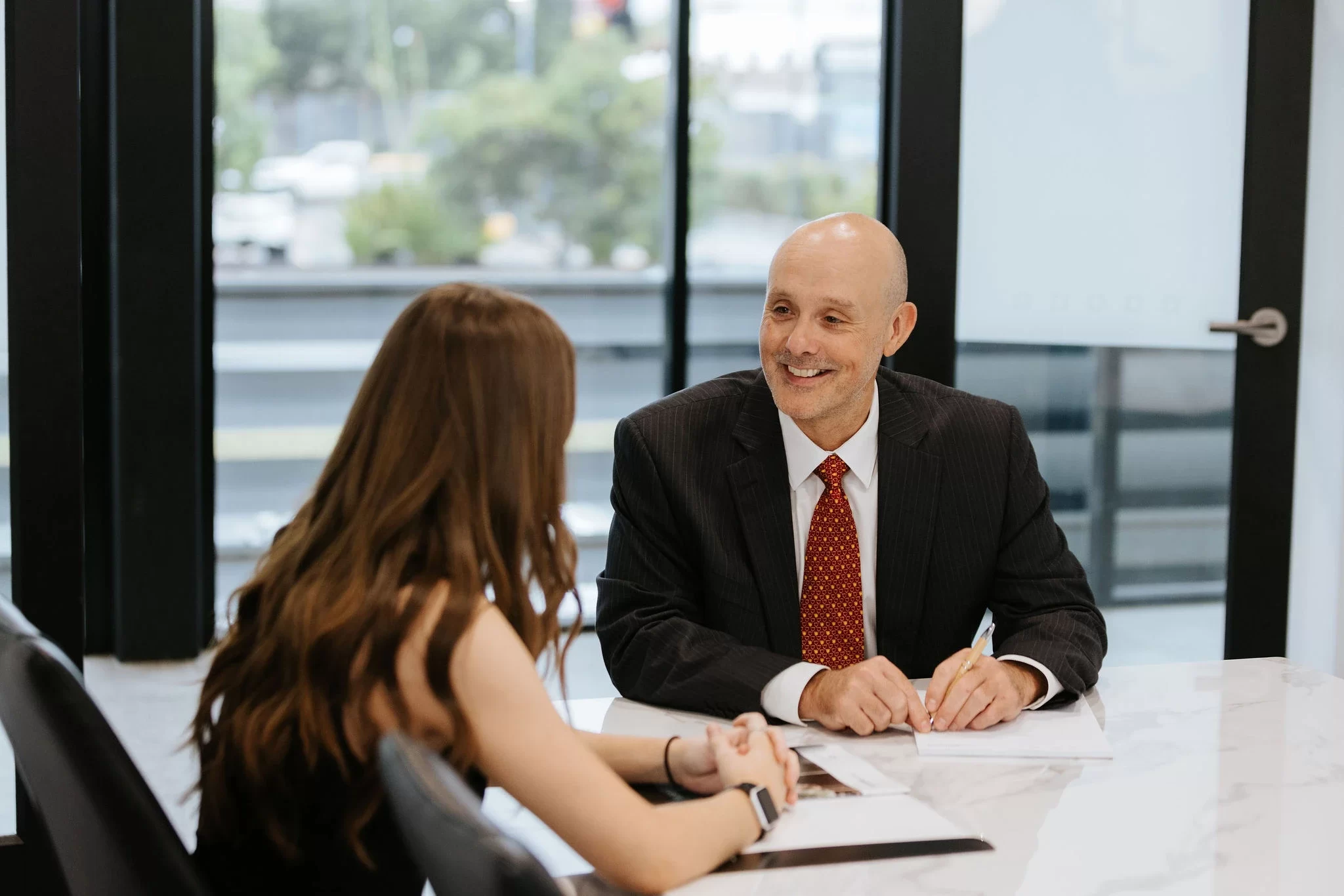 Smiling business man talking to female with long hair