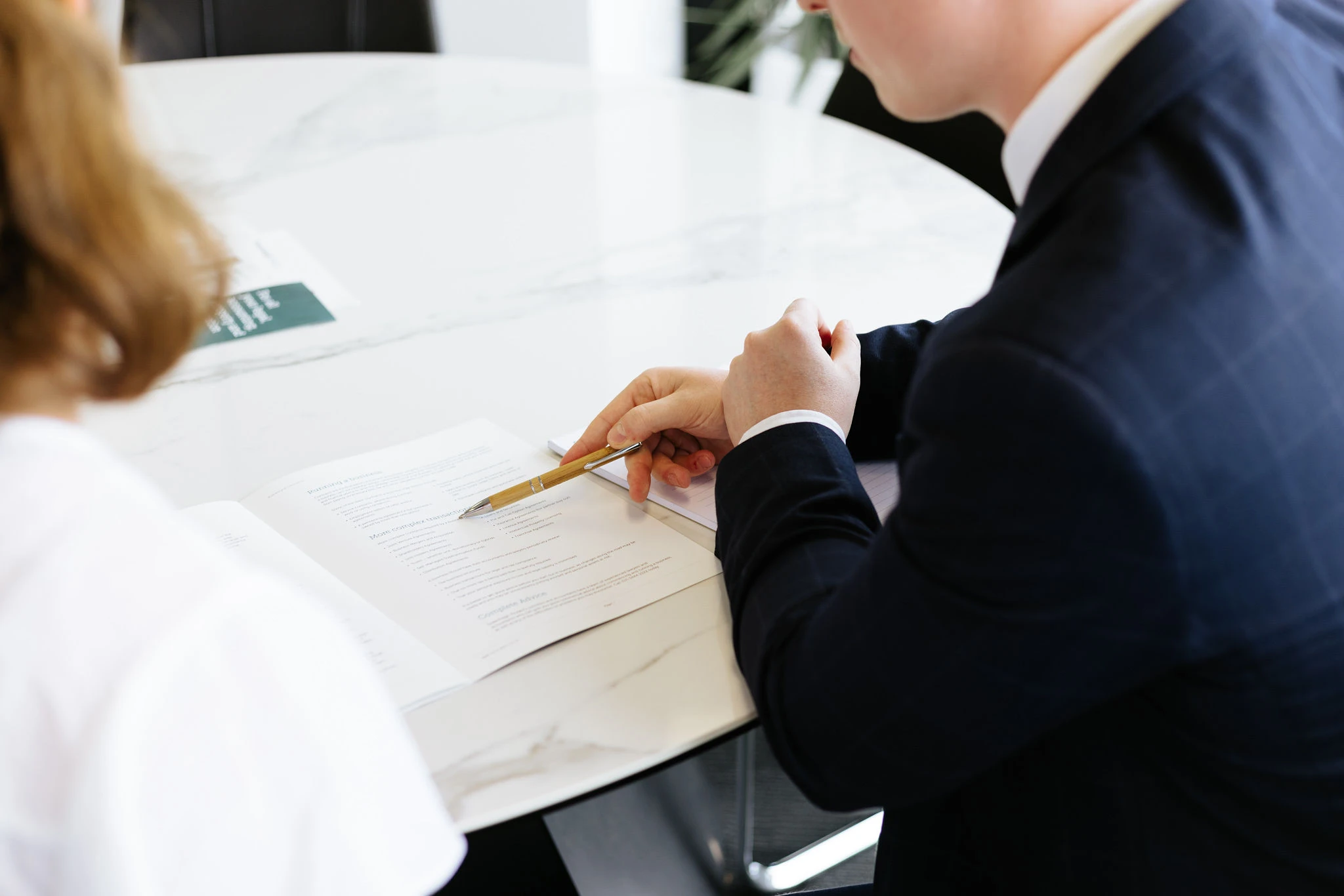 Male lawyer pointing to document with a pen