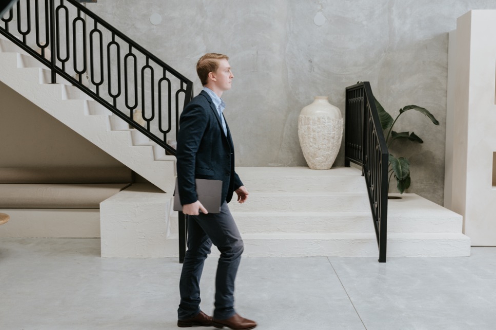 White male lawyer walking away from camera in suit